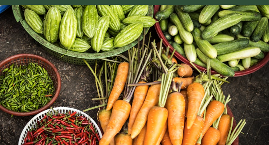 Carrots, cucumbers, and peppers at a market